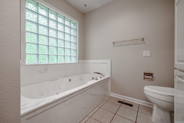 full bath with a garden tub, tile patterned floors, baseboards, toilet, and visible vents