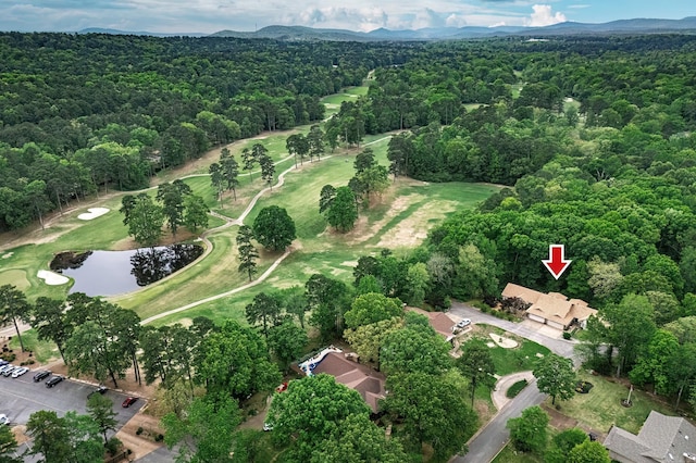 birds eye view of property with a water and mountain view, a forest view, and golf course view
