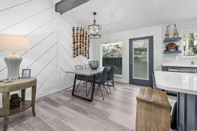 dining room featuring light wood-style flooring and an inviting chandelier