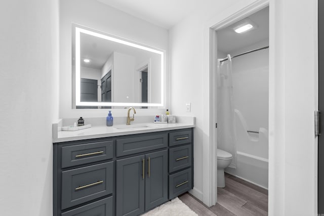 full bathroom with shower / bath combination with curtain, toilet, vanity, and wood finished floors