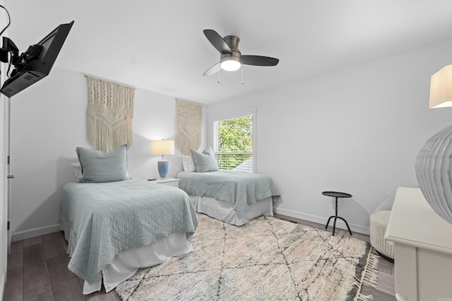 bedroom featuring baseboards, a ceiling fan, and wood finished floors