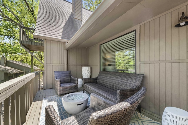 wooden terrace with an outdoor living space
