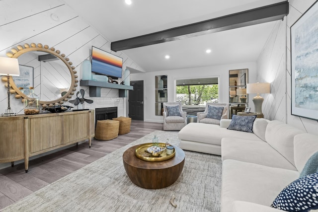 living room featuring recessed lighting, wood finished floors, a large fireplace, and lofted ceiling with beams