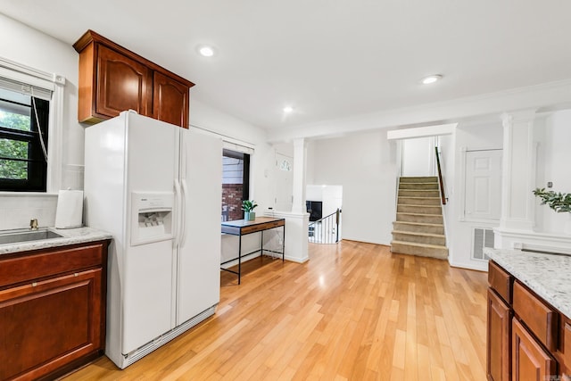2312 Breckenridge Dr, Little Rock, AR 72227 - kitchen featuring white fridge with ice dispenser, light wood-style flooring, visible vents, and light stone countertops