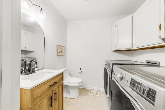 2312 Breckenridge Dr, Little Rock, AR 72227 - bathroom with tile patterned floors, toilet, separate washer and dryer, vanity, and ornamental molding