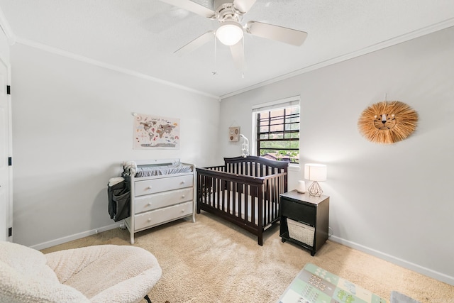 2312 Breckenridge Dr, Little Rock, AR 72227 - bedroom with a crib, ornamental molding, baseboards, light colored carpet, and ceiling fan