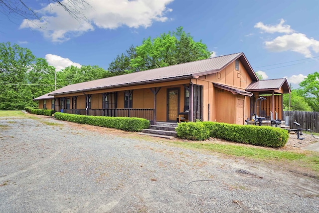5907 Jacksonville Conway Rd, Jacksonville, AR 72076 - view of front of home featuring a porch, fence, and metal roof