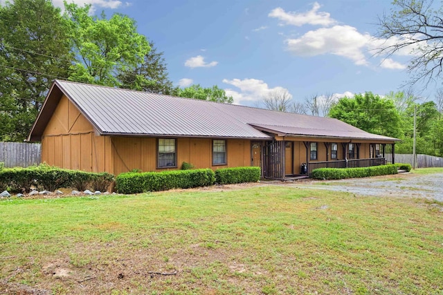 5907 Jacksonville Conway Rd, Jacksonville, AR 72076 - view of front of house with fence, metal roof, and a front yard