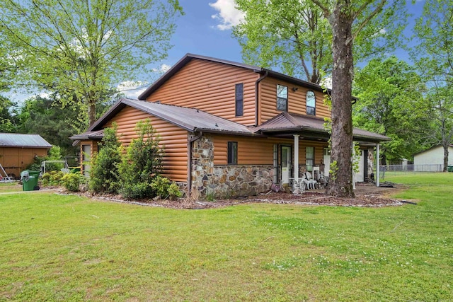 5907 Jacksonville Conway Rd, Jacksonville, AR 72076 - log cabin with log veneer siding, a front lawn, covered porch, fence, and metal roof