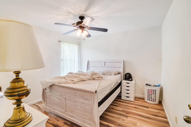 5907 Jacksonville Conway Rd, Jacksonville, AR 72076 - bedroom with baseboards, a ceiling fan, and light wood-style flooring