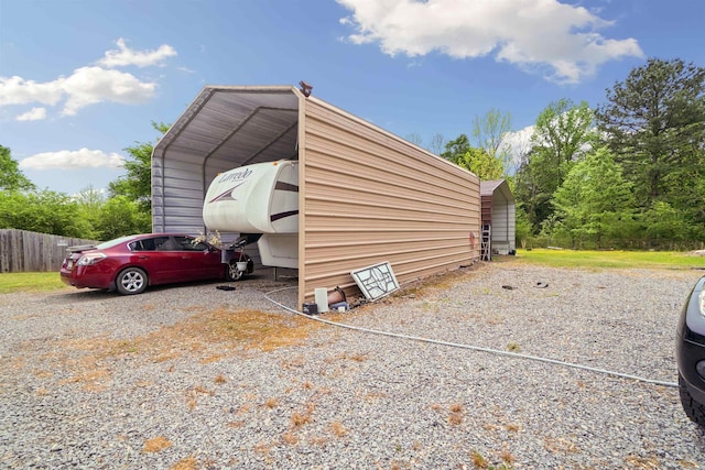 5907 Jacksonville Conway Rd, Jacksonville, AR 72076 - view of parking / parking lot featuring driveway, a carport, and fence