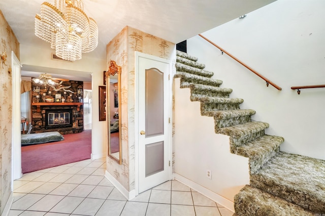 5907 Jacksonville Conway Rd, Jacksonville, AR 72076 - staircase featuring tile patterned flooring, a stone fireplace, carpet, and a notable chandelier