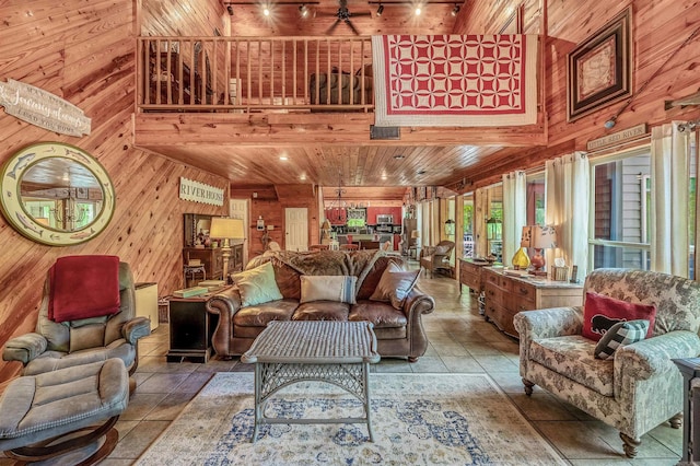 living area featuring wooden walls, a high ceiling, tile patterned floors, and wooden ceiling
