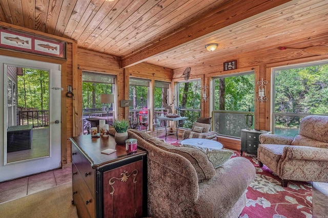living area featuring wooden walls, beam ceiling, tile patterned flooring, and wooden ceiling
