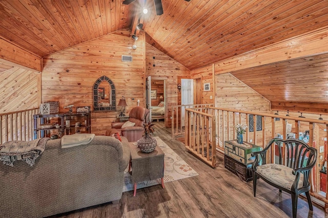 living area featuring wood walls, wooden ceiling, and ceiling fan