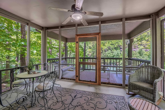 sunroom / solarium featuring a healthy amount of sunlight and a ceiling fan