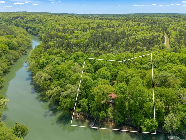 aerial view featuring a wooded view and a water view