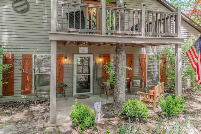 property entrance featuring a balcony and a patio