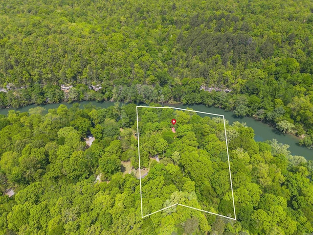 aerial view with a forest view and a water view