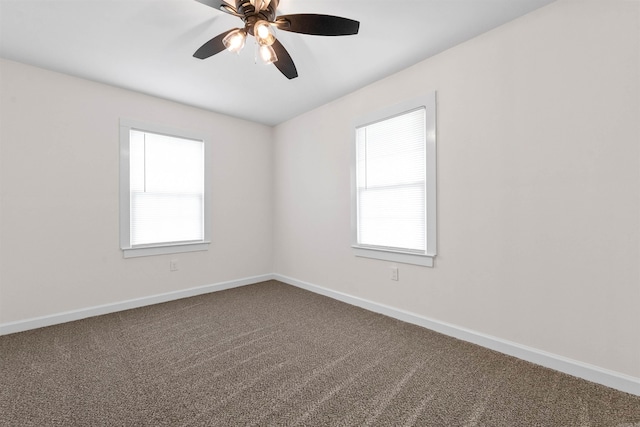 carpeted empty room with a ceiling fan, baseboards, and a healthy amount of sunlight