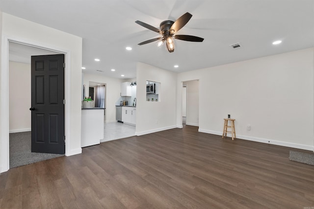 unfurnished living room featuring visible vents, a ceiling fan, dark wood-style floors, and recessed lighting