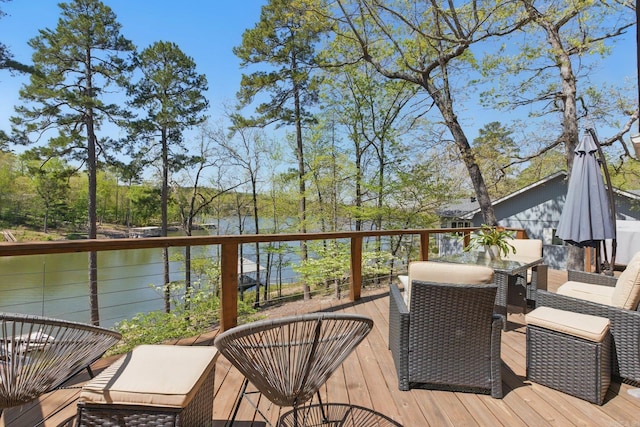 deck featuring a water view and outdoor dining area