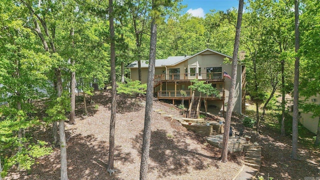 rear view of property with a deck and stairway