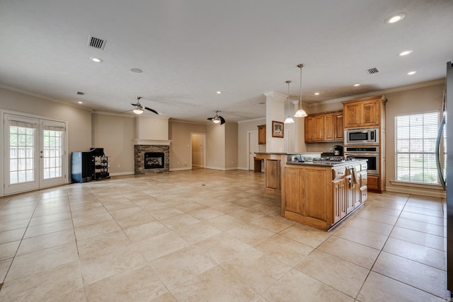 505 Fieldstone, Conway, AR 72034 - kitchen with visible vents, ornamental molding, recessed lighting, brown cabinets, and stainless steel appliances