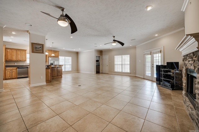 505 Fieldstone, Conway, AR 72034 - unfurnished living room featuring a ceiling fan, light tile patterned floors, a stone fireplace, and a wealth of natural light