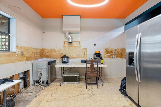 kitchen featuring light floors and stainless steel fridge with ice dispenser