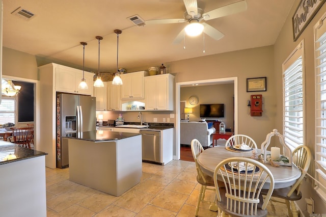 kitchen featuring visible vents, dark countertops, appliances with stainless steel finishes, and plenty of natural light