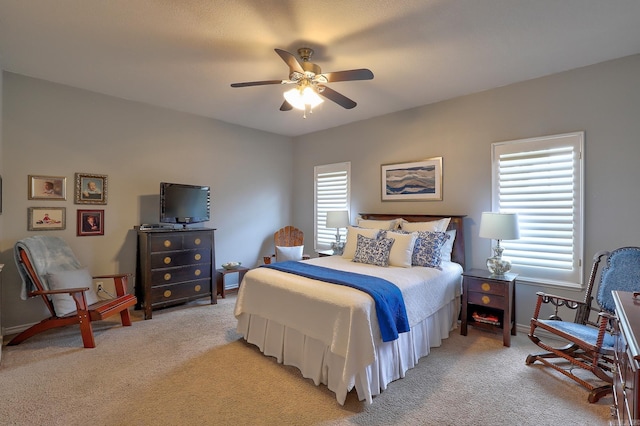 bedroom with baseboards, light carpet, and ceiling fan