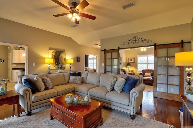 living room featuring visible vents, a barn door, and plenty of natural light