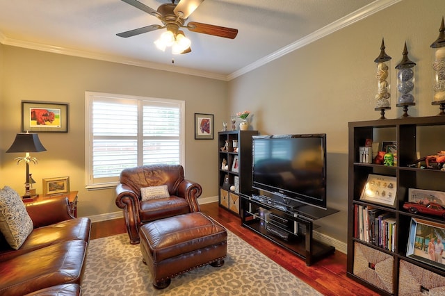 living area featuring wood finished floors, a ceiling fan, crown molding, and baseboards