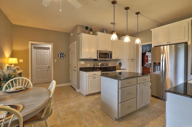 kitchen with white cabinetry, dark countertops, stainless steel appliances, baseboards, and a center island
