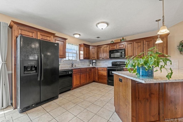 kitchen featuring black appliances, hanging light fixtures, brown cabinets, and backsplash