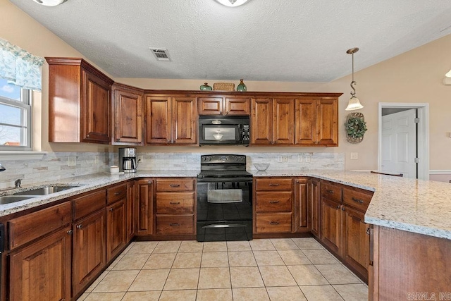 kitchen featuring brown cabinetry, black appliances, backsplash, a sink, and visible vents