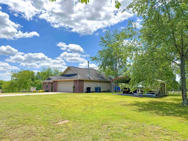 20 Jeffrey Scott Dr, Quitman, AR 72131 - view of front of property with a detached carport, driveway, an attached garage, and a front yard