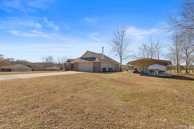 exterior space with a front yard, a garage, a carport, brick siding, and concrete driveway