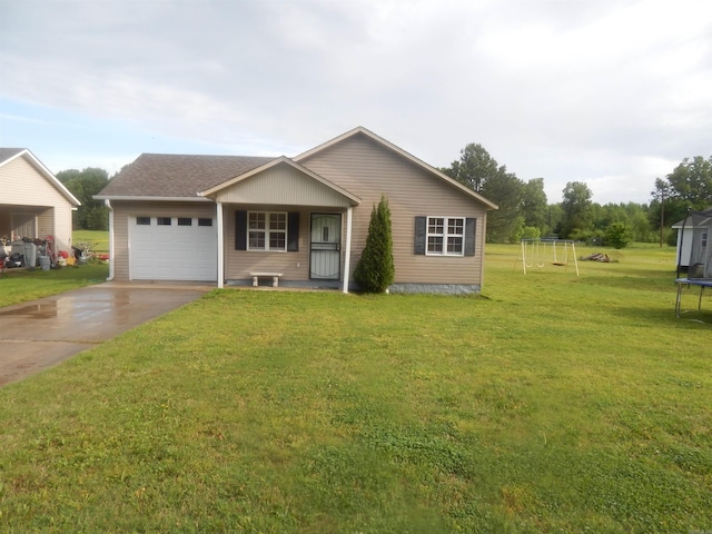 view of front facade with driveway, a front lawn, an attached garage, and a trampoline