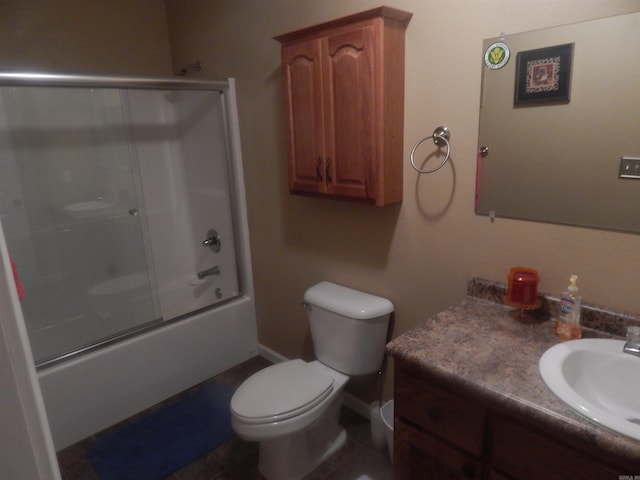 full bathroom with bath / shower combo with glass door, baseboards, toilet, tile patterned floors, and vanity