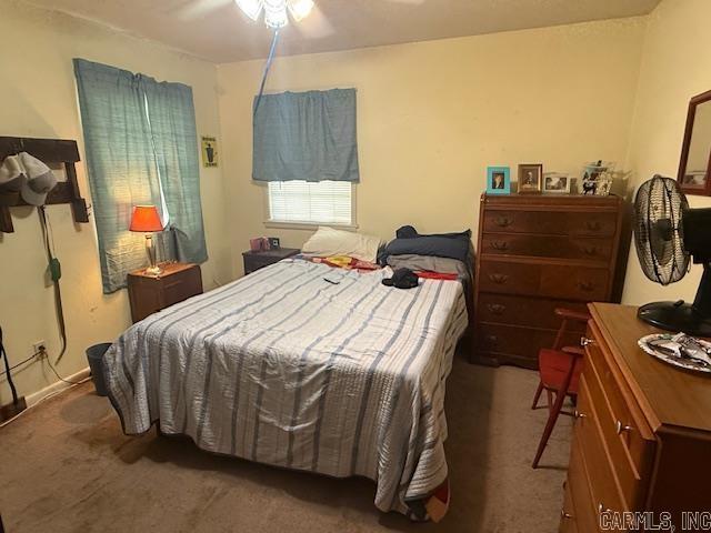 carpeted bedroom with a ceiling fan