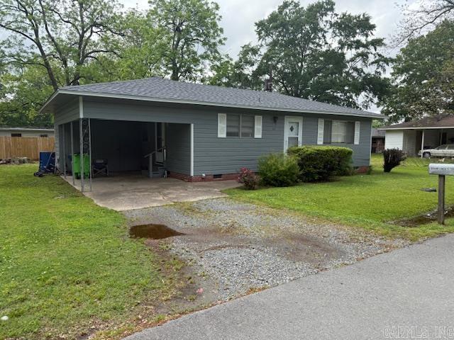 ranch-style home with a front lawn, crawl space, a shingled roof, and dirt driveway