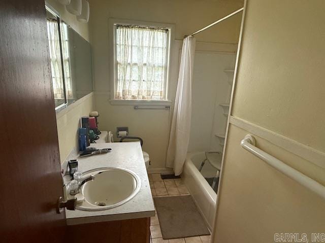 bathroom featuring tile patterned floors, shower / bathtub combination with curtain, and vanity