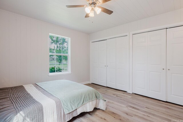 8033 Renee Cir, Benton, AR 72019 - bedroom featuring two closets, a ceiling fan, and light wood-style floors