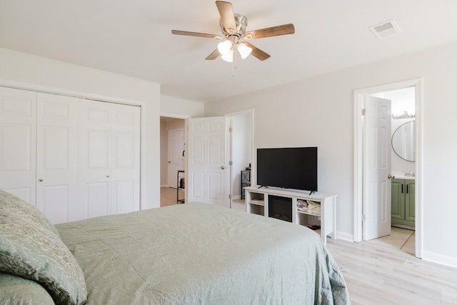 8033 Renee Cir, Benton, AR 72019 - bedroom featuring ensuite bath, light wood-style flooring, a closet, baseboards, and visible vents