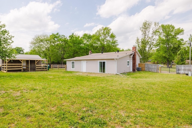 8033 Renee Cir, Benton, AR 72019 - back of property featuring a chimney, an exterior structure, an outbuilding, and central AC