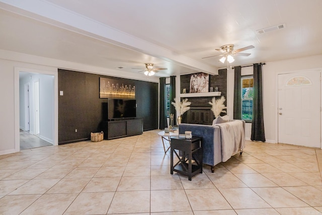 8033 Renee Cir, Benton, AR 72019 - living area featuring beam ceiling, light tile patterned flooring, ceiling fan, visible vents, and baseboards