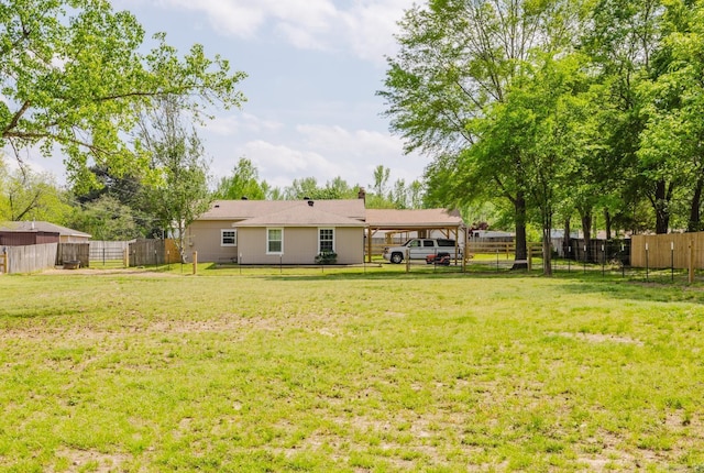 8033 Renee Cir, Benton, AR 72019 - rear view of house with a fenced backyard, a carport, and a yard