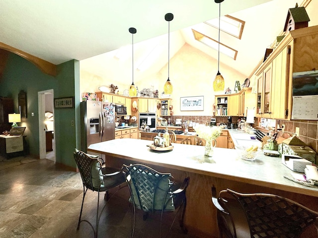2157 Pleasant Grove Rd, Wideman, AR 72585 - kitchen featuring a skylight, decorative light fixtures, appliances with stainless steel finishes, light countertops, and a peninsula